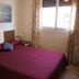 Águilas de los Collados room in Águilas with a double bed, window, and coastal wall art