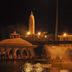 Hotel Pooja International in Nashik, nighttime view of lit fountains and a pavilion by the water