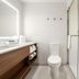 Home2 Suites by Hilton Fort Walton Beach Eglin Air Force Base bathroom with vanity, toilet, and glass shower
