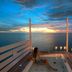 Diamonds Thudufushi Beach & Water Villas overwater deck with jacuzzi and sunset ocean view