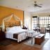 Hacienda La Magdalena in Zapopan: spacious hotel room with wrought-iron bed, sitting area, and windows