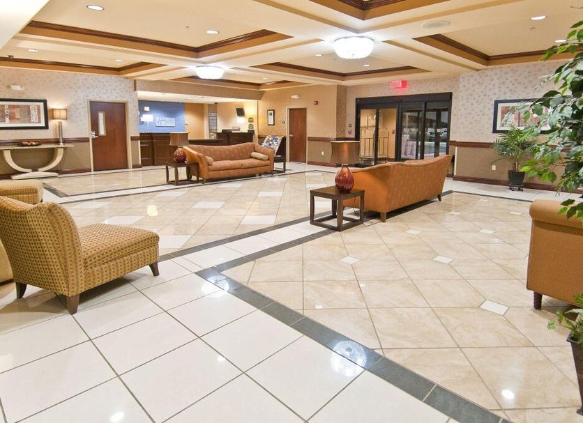 Holiday Inn Express & Suites Biloxi- Ocean Springs lobby with seating area and polished tile floors