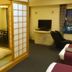 Asahikawa Park Hotel in Asahikawa: Japanese-style tatami room with futon, TV, and city view