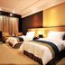 Haobo International Hotel in Wuxi guest room with two twin beds and warm lighting