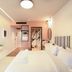 Pavo Art Hotel in Heraklion guest room with striped headboard, wall-mounted TV and glass shower area