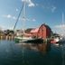 Rockport Inn and Suites in Rockport with harbor sailboats beside a red waterfront building