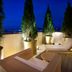 Aloft Seoul Gangnam rooftop terrace with lounge chairs, potted trees and city views at night
