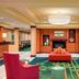 Fairfield Inn & Suites by Marriott Huntingdon Route 22/Raystown Lake lobby with red chairs and fireplace