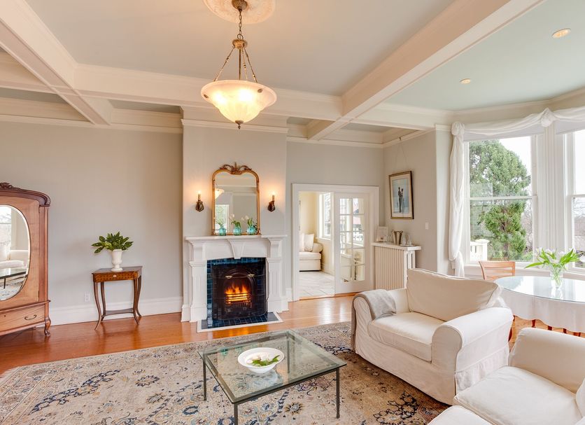 Fairholme Manor Inn, Victoria: elegant lounge with fireplace, bay window seating, and garden views