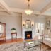 Fairholme Manor Inn, Victoria: elegant lounge with fireplace, bay window seating, and garden views
