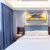 Longwan Hotel (Foshan Ceramics City) guest room with a neatly made bed and blue curtains in Foshan