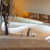 Regency Inn Richmond in Richmond: jetted bathtub with candles and beige tiled bathroom