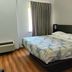 Baymont by Wyndham San Antonio Airport guest room with king bed, window and wood flooring