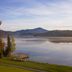 Lake Placid Lodge in Lake Placid: lakeside gazebo, mountain views and calm water at sunset