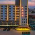 OYO Hexi Hotel in Zhangye exterior at dusk with illuminated facade and parking lot