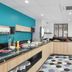Appart'City La Rochelle breakfast area with buffet counter, tables, and teal accent wall