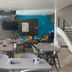 Hotel Dorado Ferial Bogotá lobby seating area with tables, chairs, wall TV and staircase