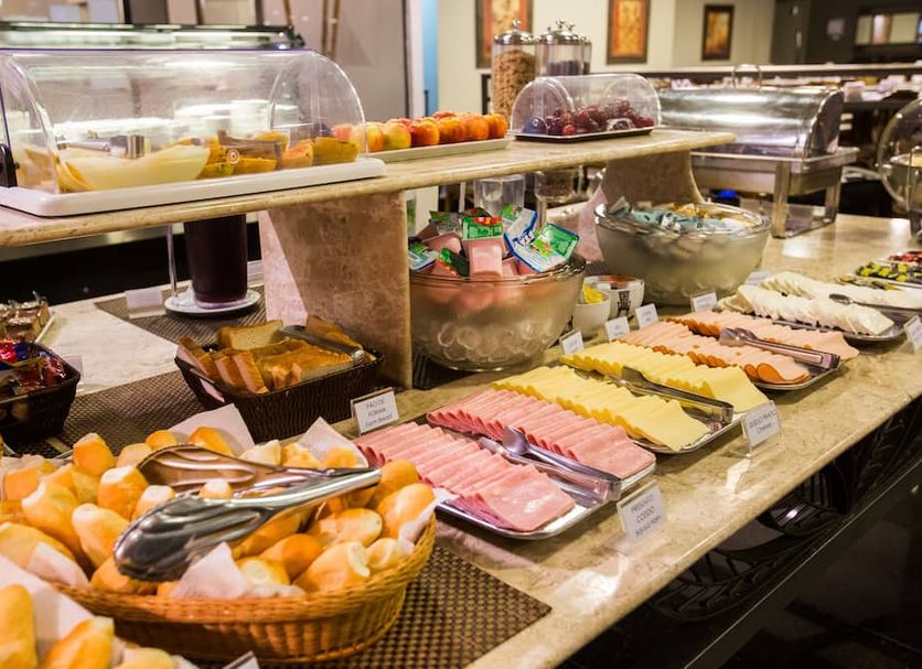 Breakfast buffet at Gallant Hotel in Rio de Janeiro with pastries, sliced meats and fruit trays