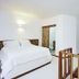 Otro Lado Lodge And Restaurant Santa Teresa bedroom with four-poster bed and open shelving