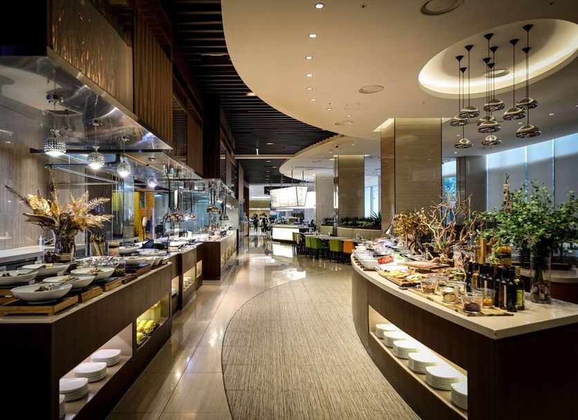 Novotel Ambassador Suwon buffet restaurant interior with modern dining stations in Suwon