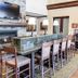 Hampton Inn & Suites Pinedale lobby seating area with stone fireplace, long table, and coffee station
