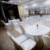 The Grand Radiant Hotel in Lucknow banquet hall with round tables and white chair covers