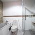 Ao Nang Beach Resort bathroom in Krabi with bathtub, toilet, and glass shower enclosure