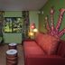 Disney's Art of Animation Resort room with colorful sofa, green chair, animal-themed wall art and window view