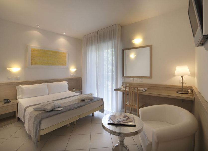 Hotel Gala Riccione guest room with double bed, desk, armchair and balcony door