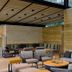 Rodavento Valle de Bravo lounge with seating area, wood walls, and floor-to-ceiling windows