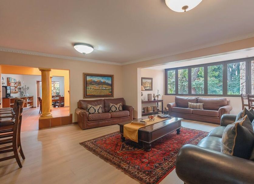 Sunward Park Guest House & Conference Centre lounge in Boksburg with sofas, coffee table and large windows