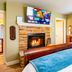 J Patrick Inn in Cambria guest room with fireplace, TV, window seat and large window