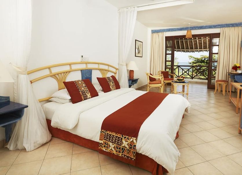 Neptune Beach Resort in Mombasa guest room with king bed and balcony ocean view