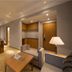 Yong Cun Hotel (Xi'an Bell Tower) in Xi'an, modern suite with seating area, TV, and warm lighting