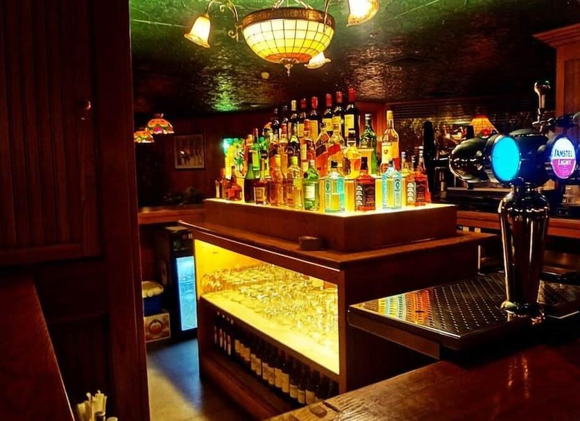 Mansouri Mansions Hotel, Manama bar with illuminated liquor bottles and beer taps