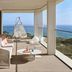 W Algarve balcony with lounge seating, glass railing, and ocean view in Albufeira