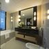 Asdal Boutique Hotel Seef, Manama bathroom with glass shower, bathtub, vanity and large mirror