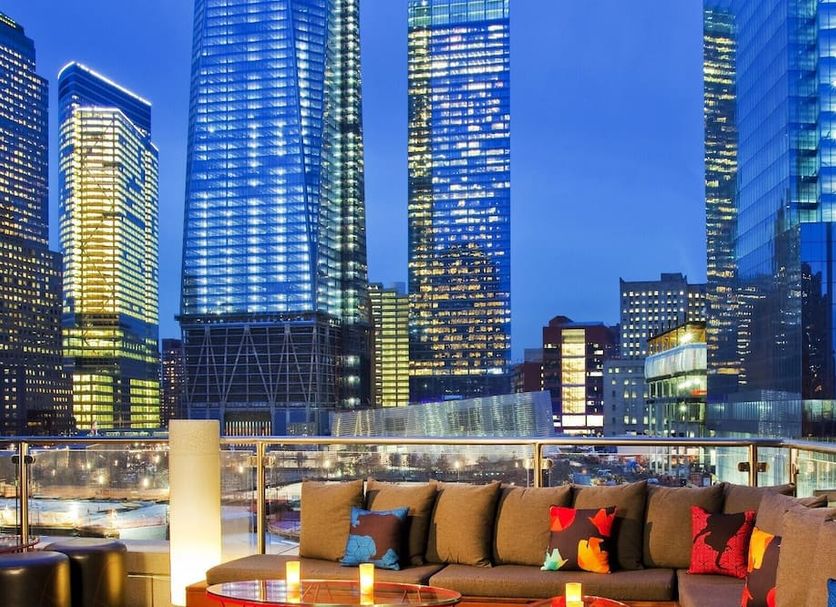 Rooftop terrace at The Washington Nyc in New York with city skyline views and lounge seating