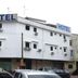 Skudai Baru Hotel in Skudai, white corner hotel building with rooftop HOTEL signs and parked cars