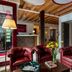 Lobby seating area at UNAHOTELS Eco Hotel Villa Costanza Venezia in Venice with red leather chairs and sofa