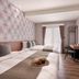 Muzik Hotel - Ximending Xining Branch guest room with two beds, desk, wall-mounted TV and balcony doors in Taipei City