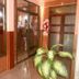 Hosteria Maryland in Posadas hallway with glass doors, tiled floor, brick walls, and potted plant