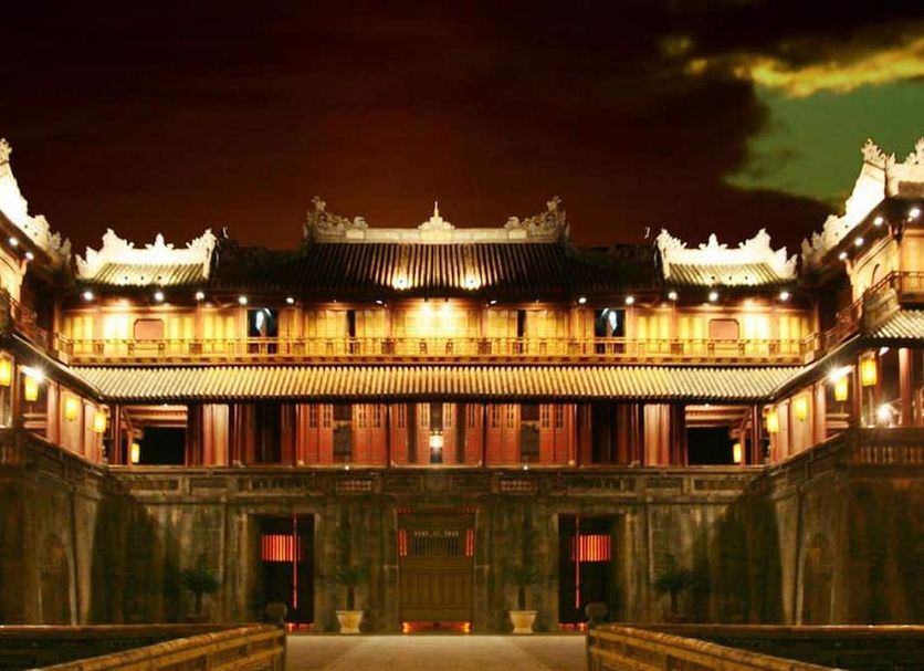 Thai Binh II Hotel in Hue at night, showing an illuminated traditional-style facade and courtyard