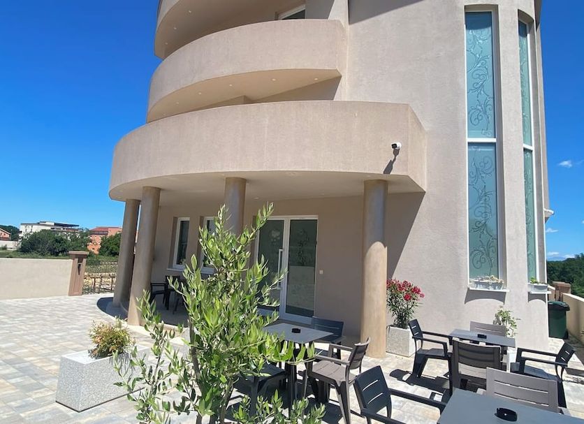 Villa Flowers in Medjugorje with curved balconies, terrace seating, and potted plants