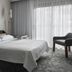 Courtyard by Marriott Lincroft Red Bank guest room with king bed and floor-to-ceiling window