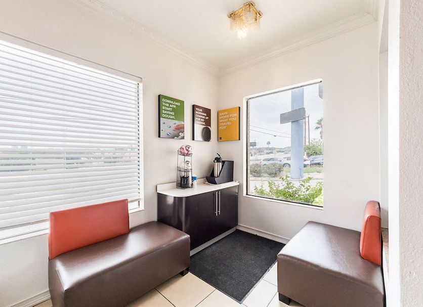 Motel 6 San Antonio - Fiesta Trails lobby seating area with window views in San Antonio