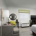 Hampton Inn & Suites El Paso-East guest room with bed, desk, TV, window and modern seating