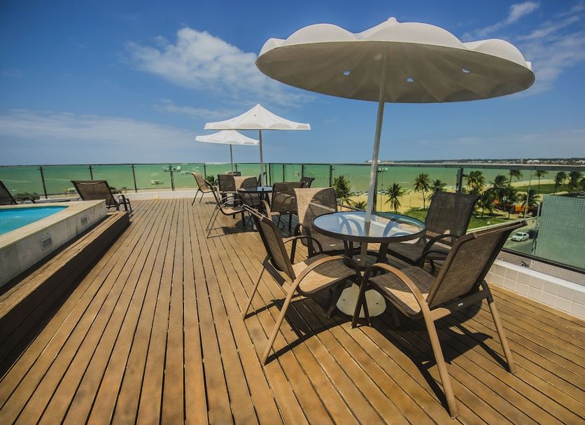 Hotel Corais de Tambau rooftop terrace in João Pessoa with tables, chairs, and ocean view