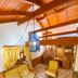 Pousada O Cantinho da Raposa in Monte Verde with loft bed, wooden ceiling, and cozy seating area