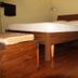 B&B Gildo Trani guest room with wooden bed, side table and polished hardwood floor in Trani